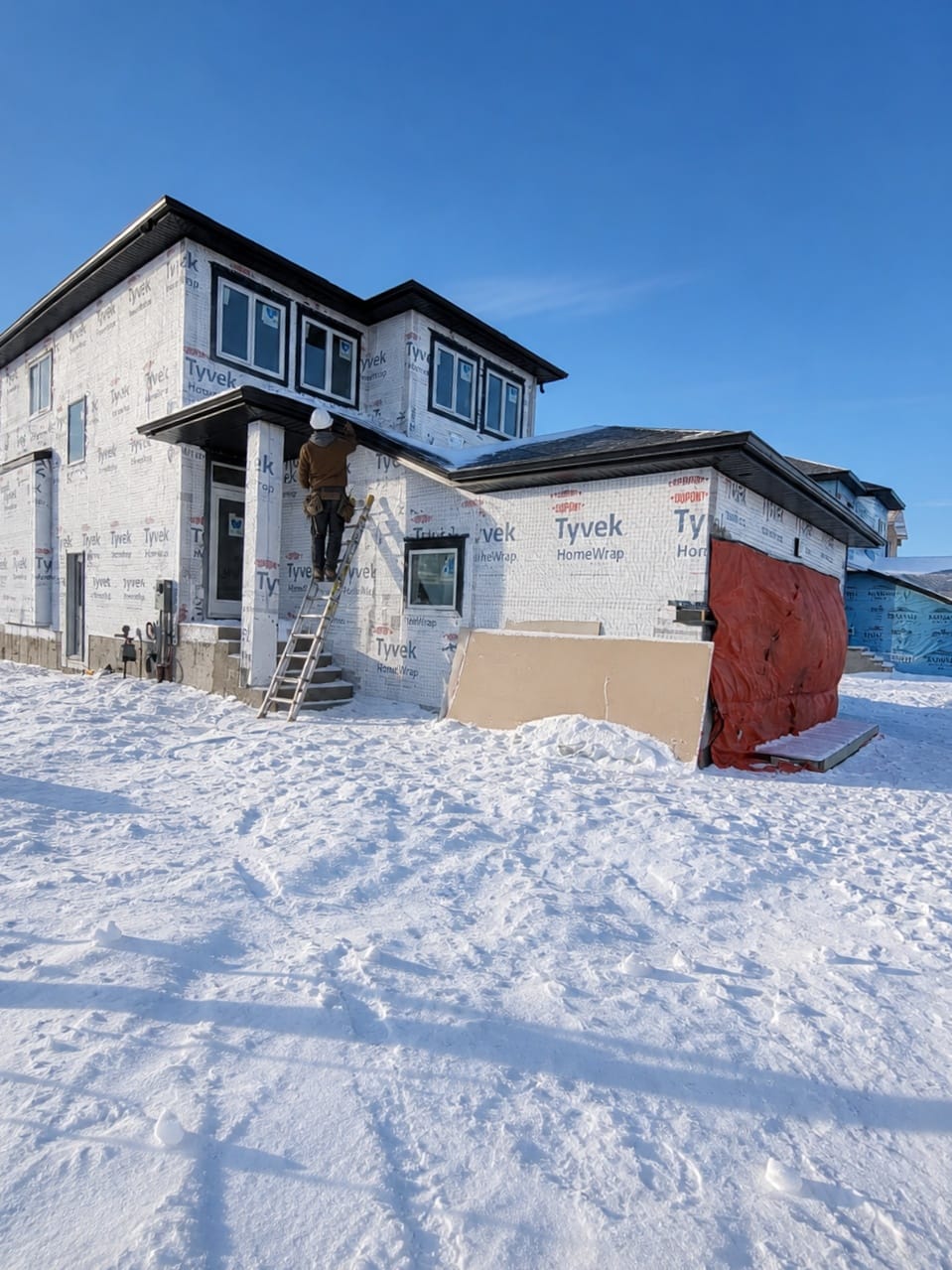 Tyvek wrapped home with driveway